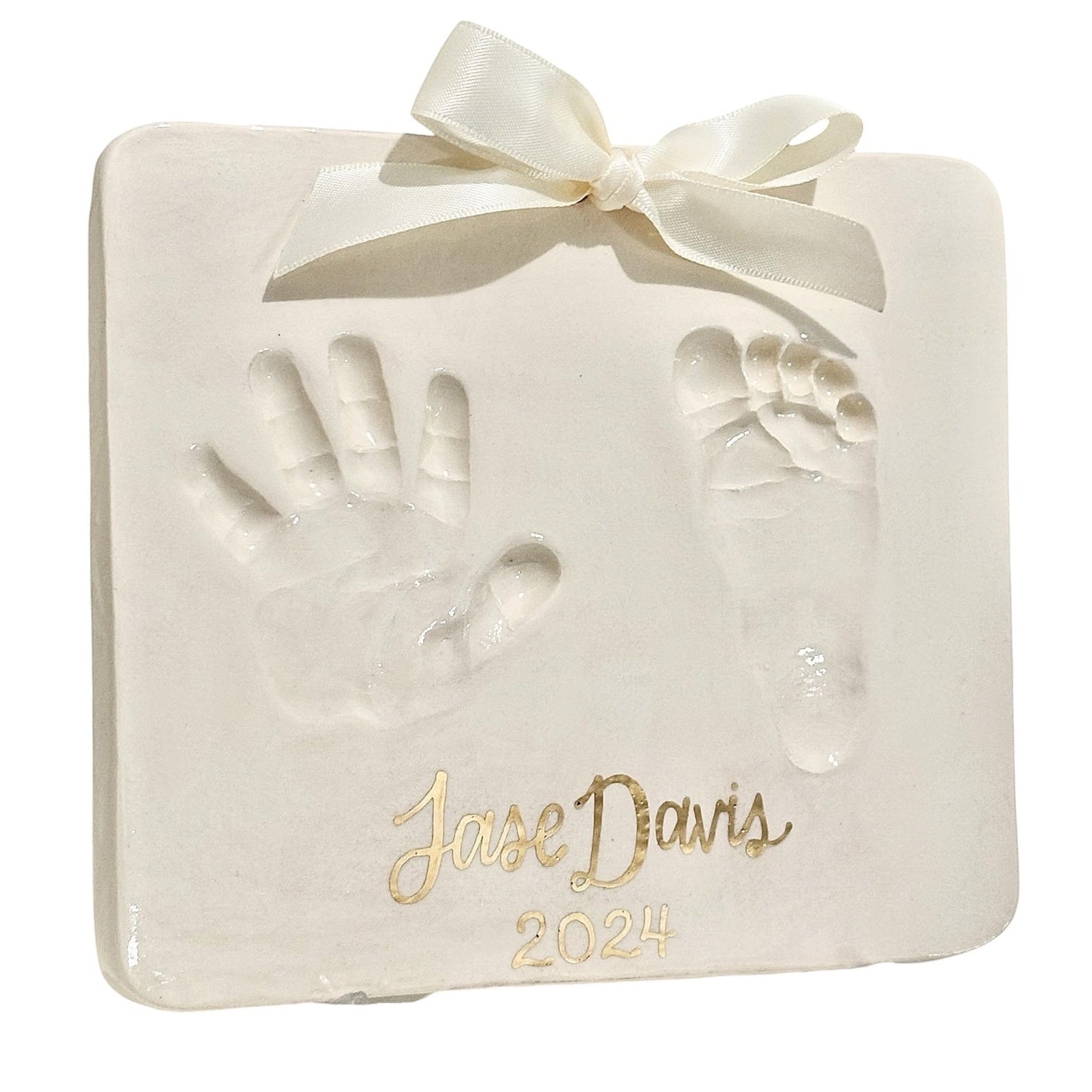 Weeks Studio custom off-white baby handprint and footprint plaque with gold name and year and cream ribbon bow