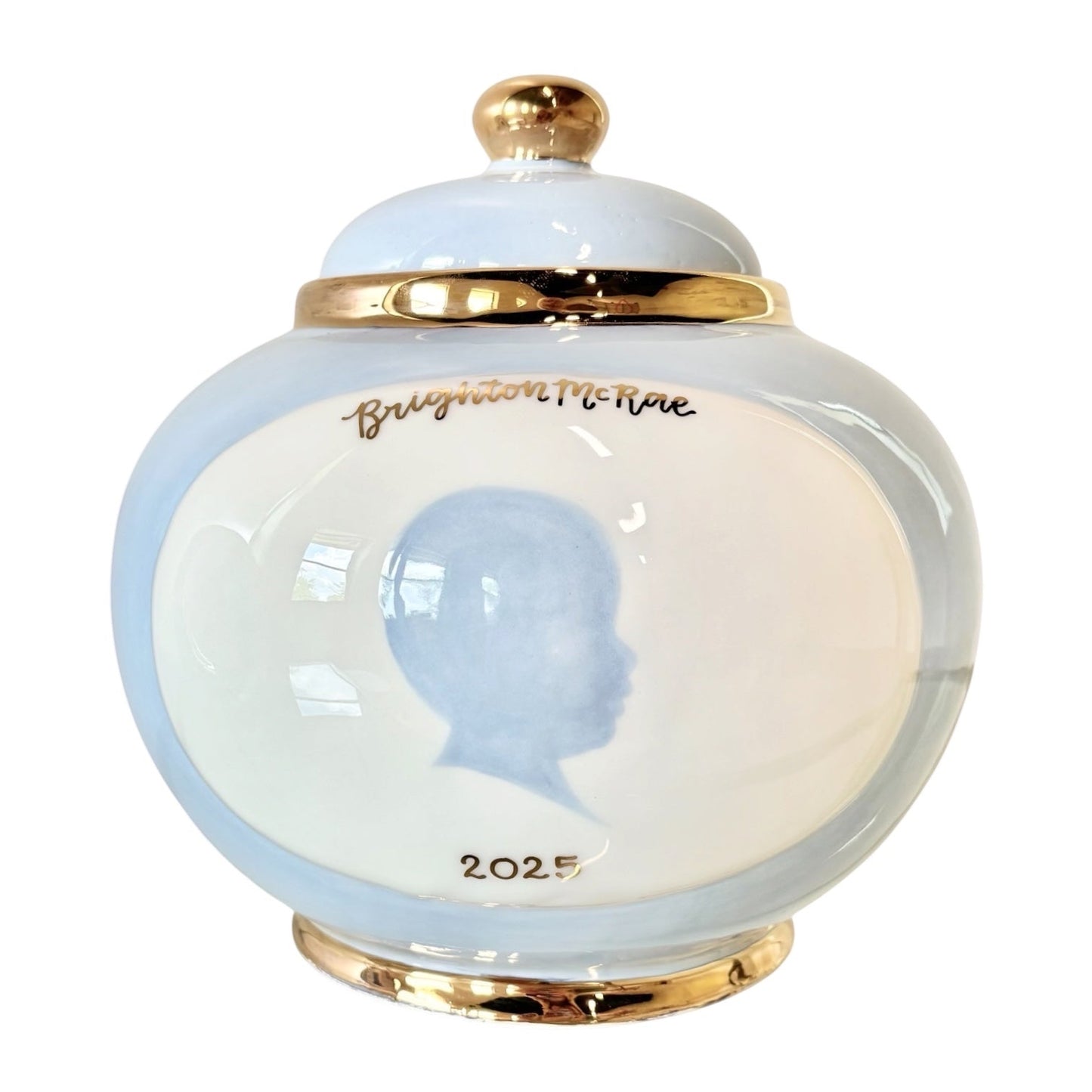 Weeks Studio large ceramic canister with light blue finish, gold trim, and a custom baby silhouette portrait.
